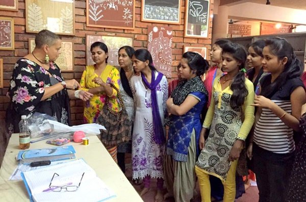 Young women watching a demonstration at a community center in Delhi
