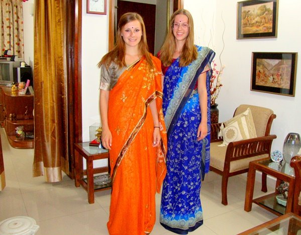 Two volunteers wearing saris