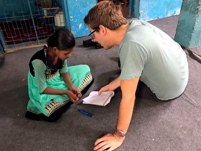 Sander helping a girl with her schoolwork