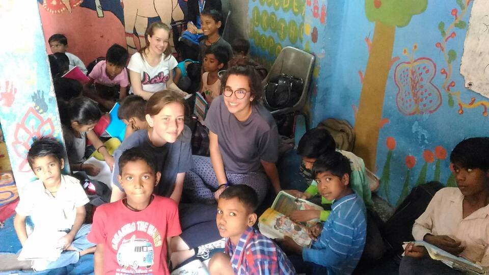 Volunteers reading with children at a children’s center