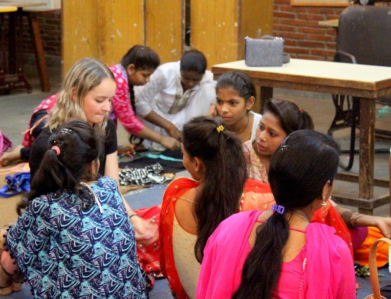 Volunteers with women at a community center