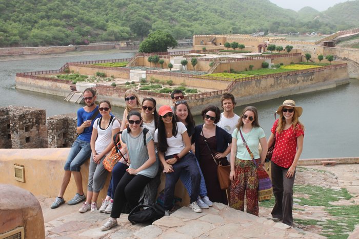 A group of young volunteers at Amber Fort in Jaipur, with Maota Lake behind them