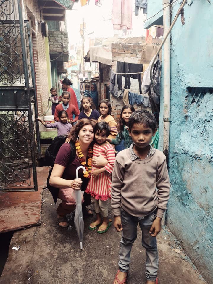 Daphne with children in a narrow lane in Delhi