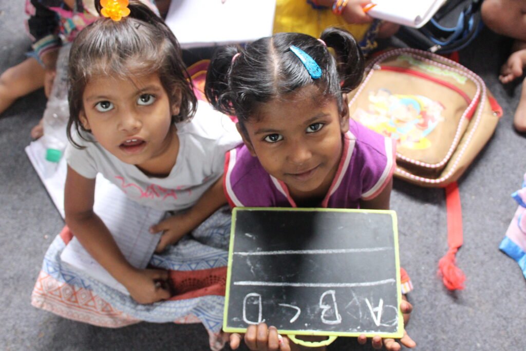 Two girls showing their slate during a lesson