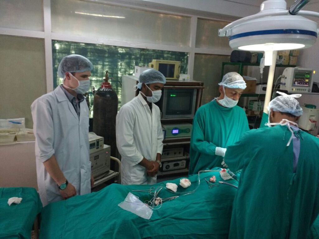 Medical interns observing surgery in an operating theater