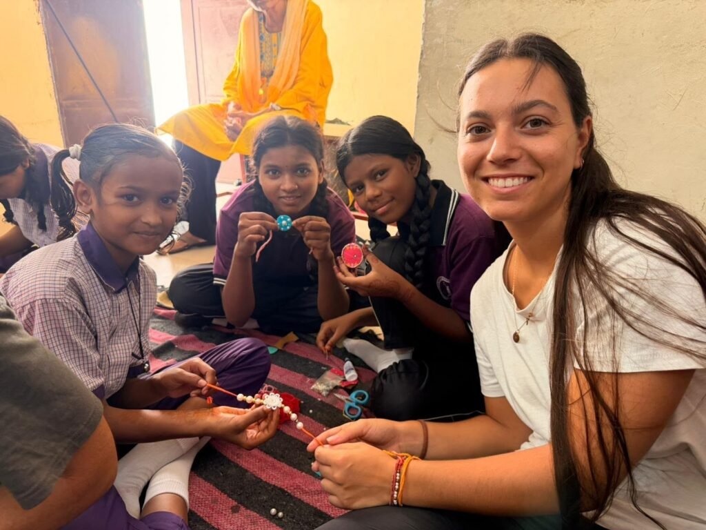 A volunteer making crafts with girls at a children’s center in Jaipur