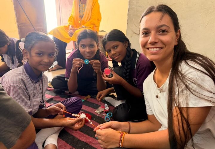 A volunteer making crafts with girls at a children’s center in Jaipur