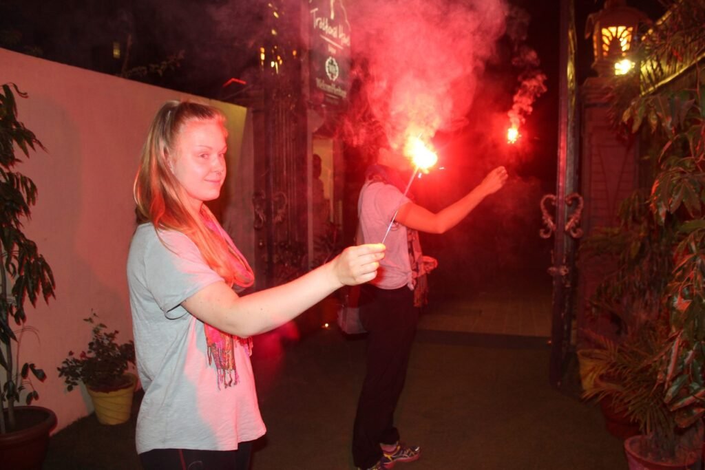 A volunteer lighting a sparkler during Diwali in Jaipur