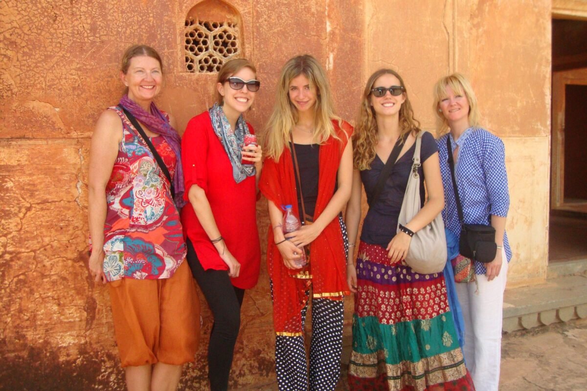 Volunteers against a sandstone fort wall on the Golden Triangle tour