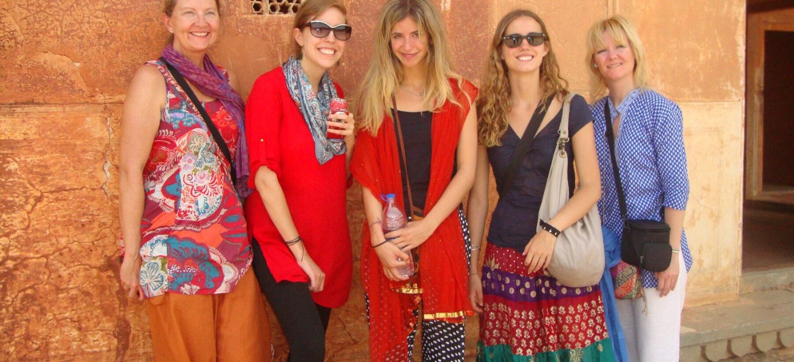 Volunteers against a sandstone fort wall on the Golden Triangle tour
