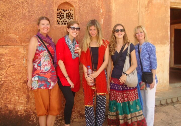 Volunteers against a sandstone fort wall on the Golden Triangle tour