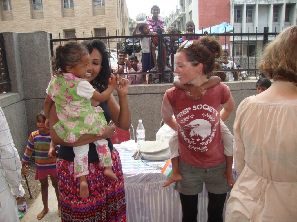 Volunteers and children at a Holi celebration in Delhi