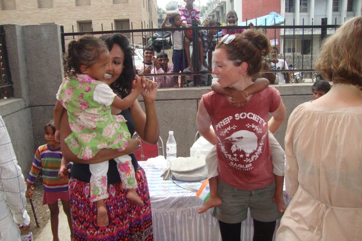 Volunteers and children at a Holi celebration in Delhi