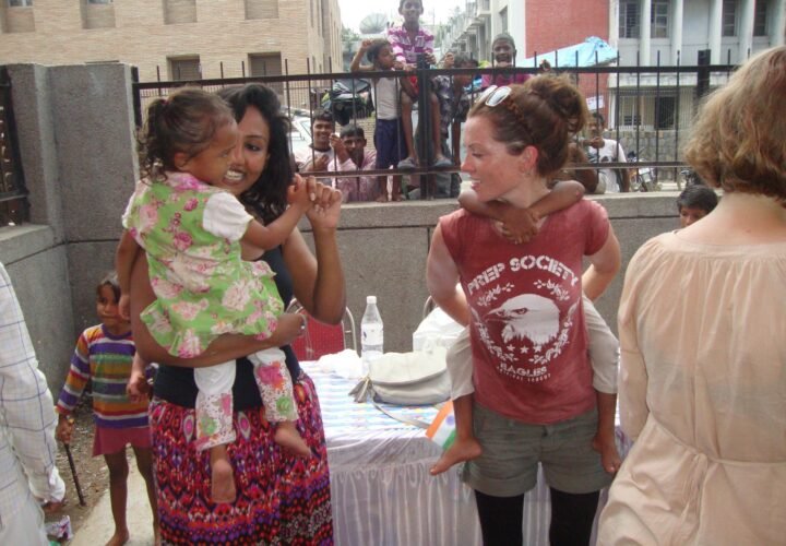 Volunteers and children at a Holi celebration in Delhi