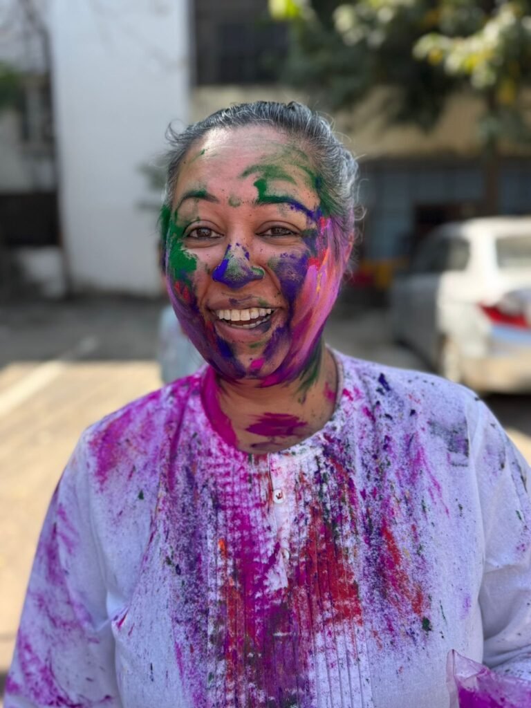 A volunteer covered in Holi colors in Jaipur
