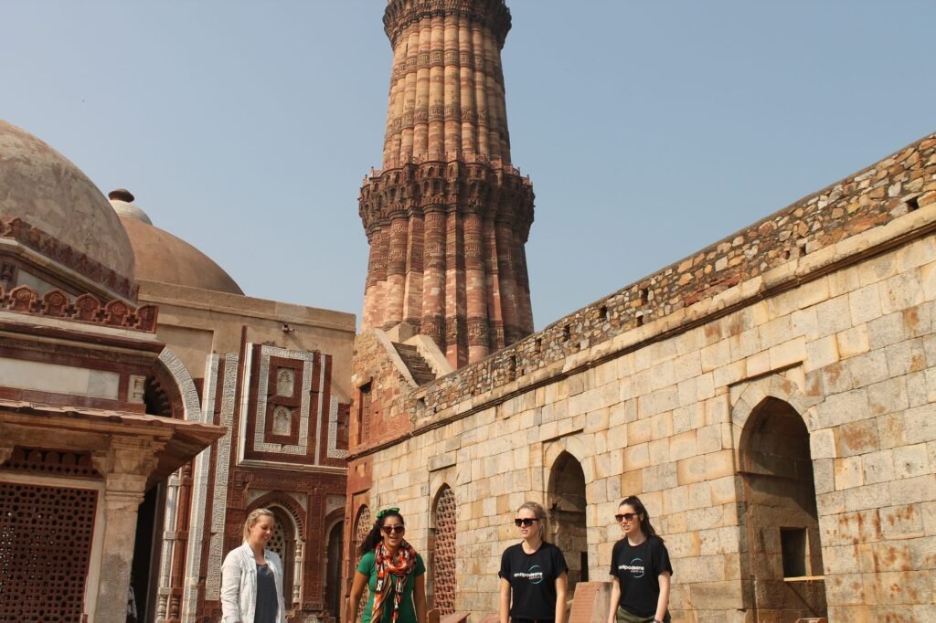 Volunteers beneath the Qutub Minar in Delhi