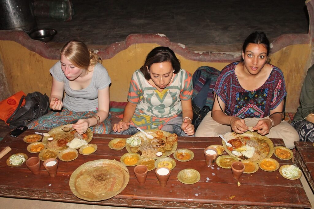 Volunteers sharing a traditional Rajasthani meal near Jaipur