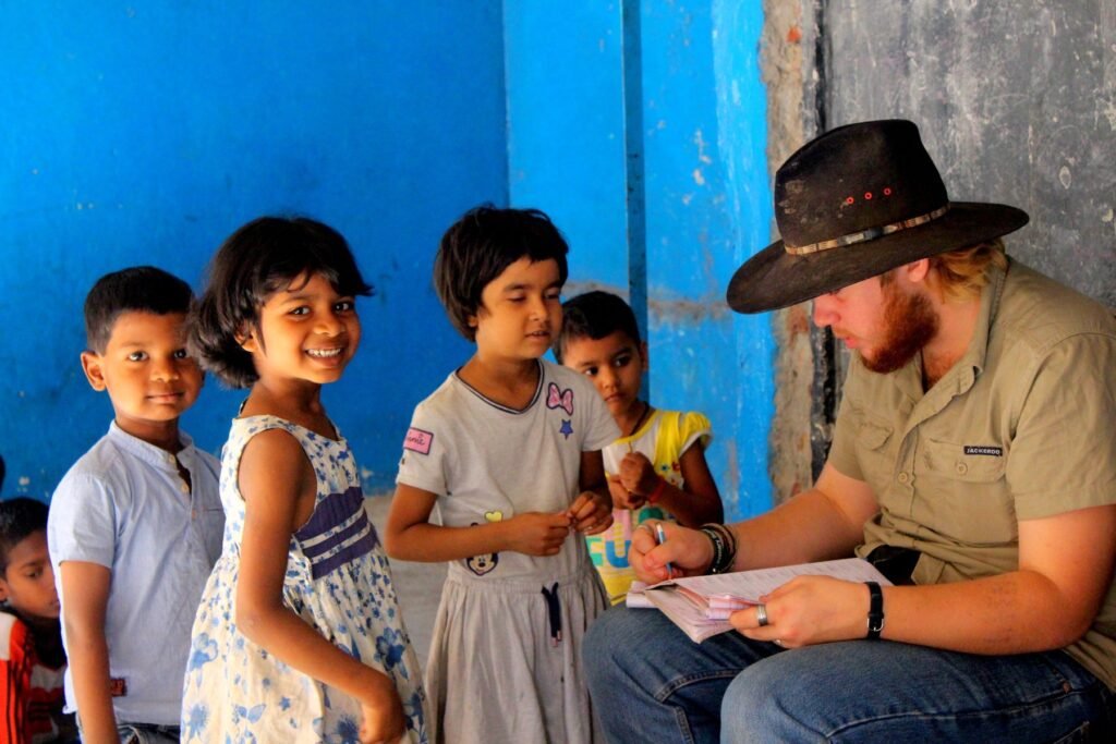 A volunteer going through a worksheet with children at a shelter home in Delhi