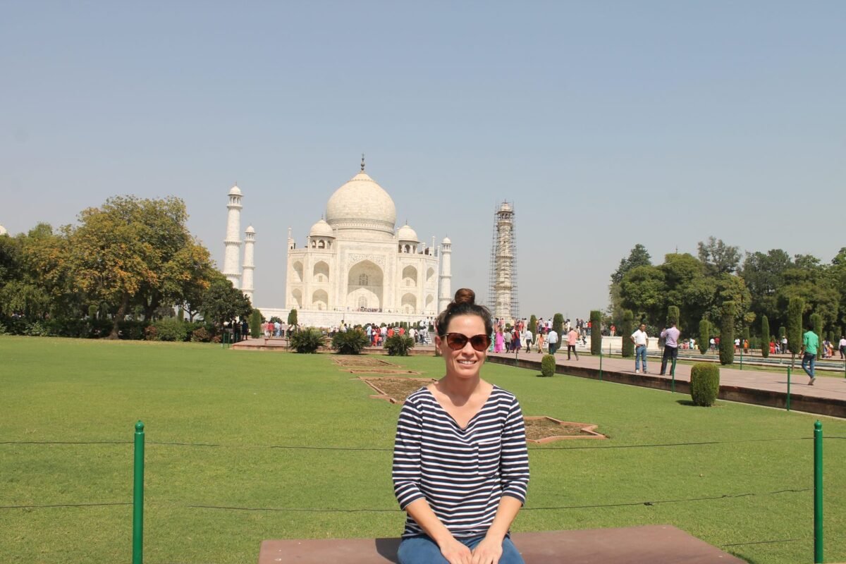A volunteer sitting on the lawn in front of the Taj Mahal
