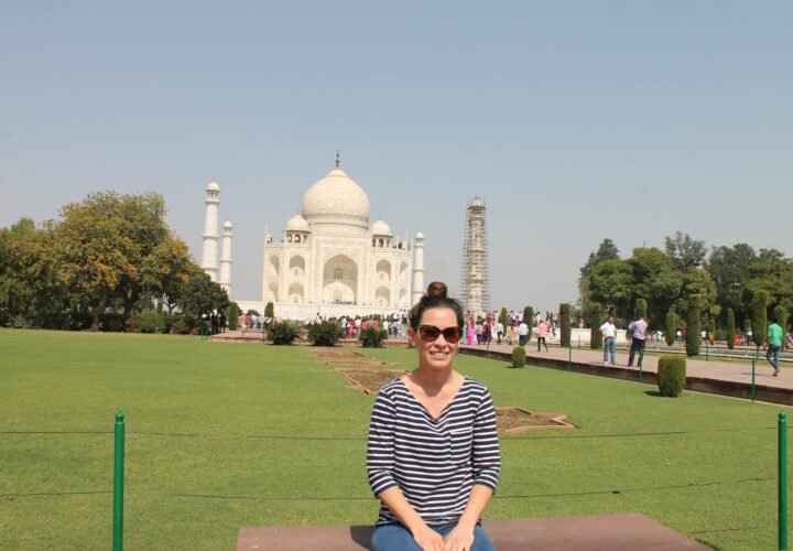 A volunteer sitting on the lawn in front of the Taj Mahal