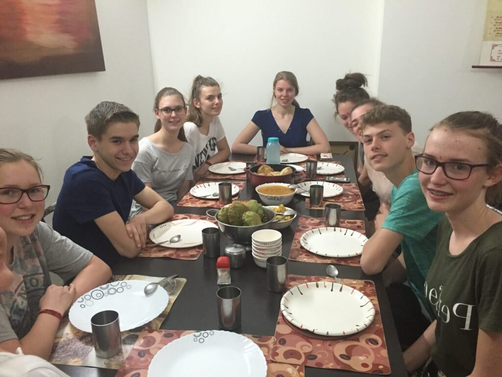 Volunteers sitting down to dinner together in Delhi