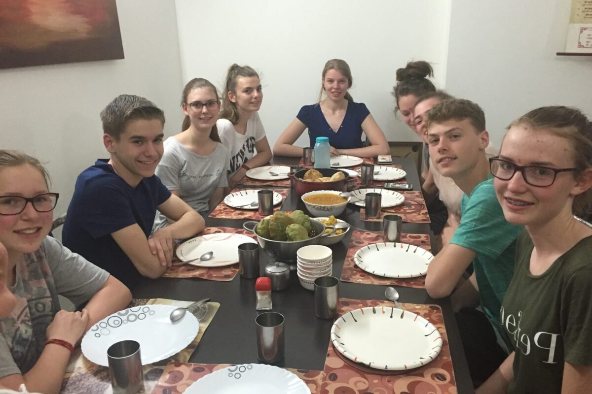 Volunteers sitting down to dinner together in Delhi