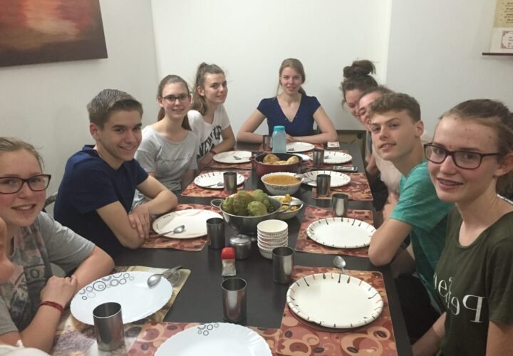 Volunteers sitting down to dinner together in Delhi
