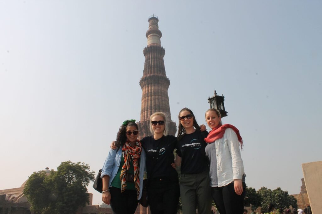 A group of volunteers in front of the Qutub Minar