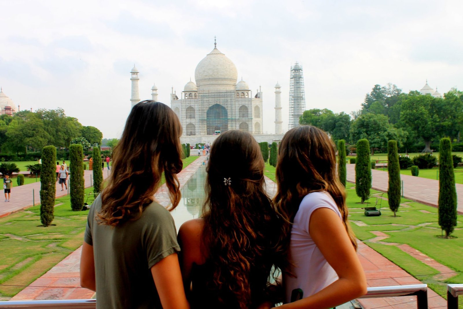 Three volunteers looking at the Taj Mahal from the garden path in Agra