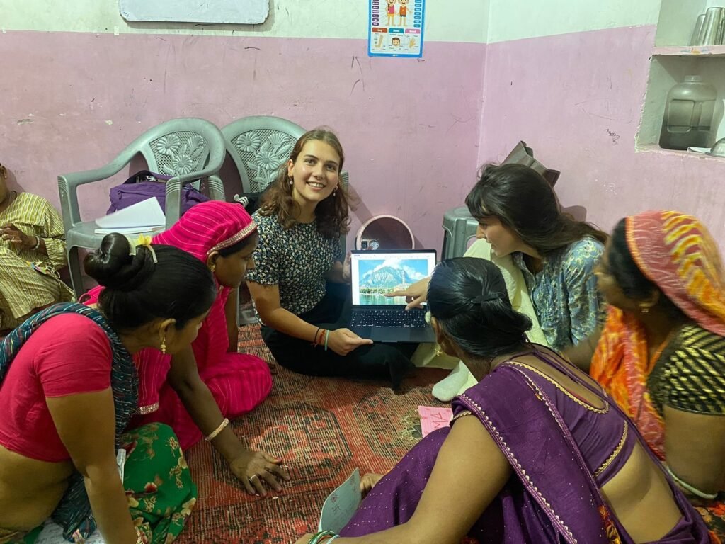 Volunteers using tablets with women at a community center in Jaipur