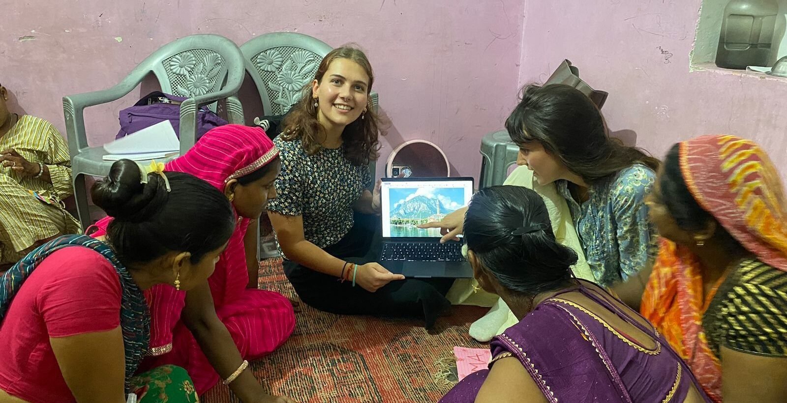 Volunteers using tablets with women at a community center in Jaipur
