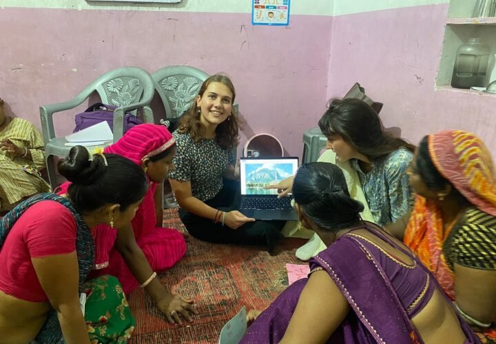 Volunteers using tablets with women at a community center in Jaipur