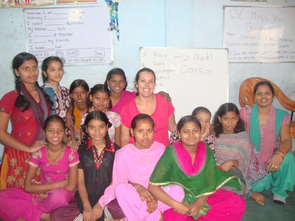 A volunteer with women and girls after an English lesson at a community center in Delhi